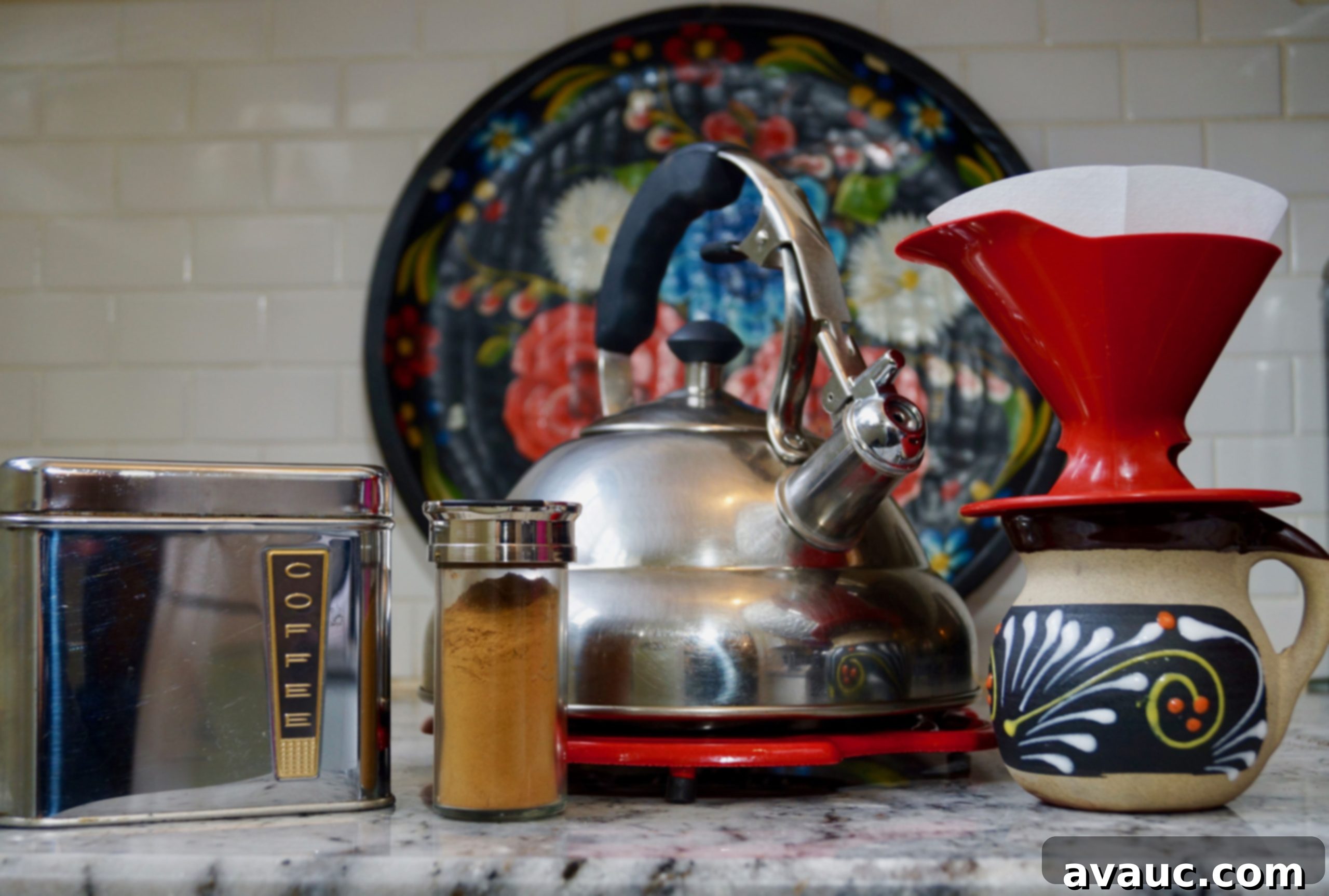 Tools and ingredients for making Mexican style pour-over coffee, including coffee beans, cinnamon, a pour-over dripper, and a coffee mug.