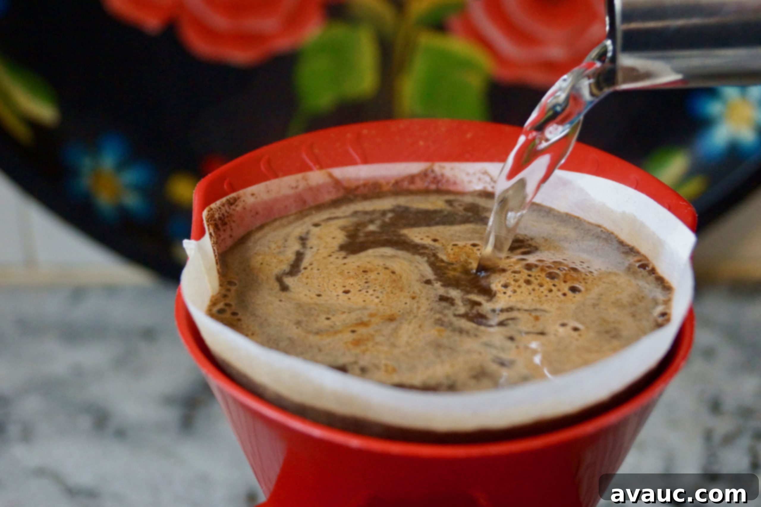 Slowly pouring boiling water into a pour-over coffee dripper.