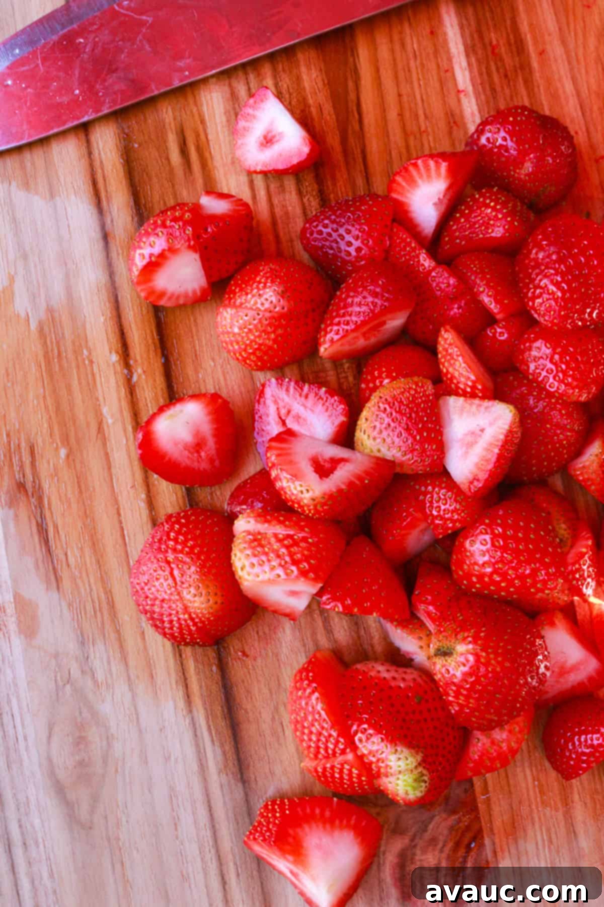 Strawberry Limeade 6 Freshly cut strawberries on a wooden cutting board, ready for blending