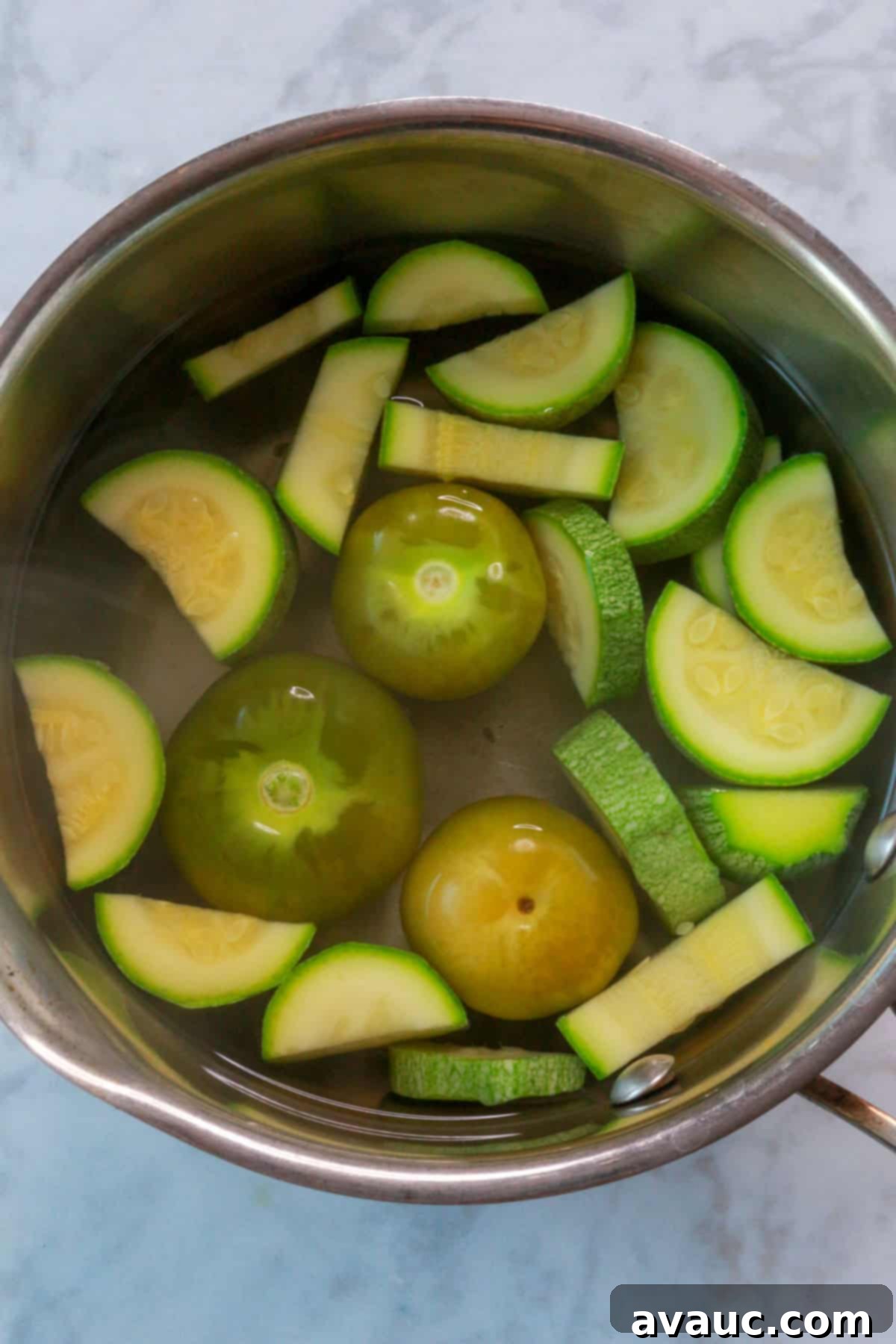 Mockamole 6 Chopped zucchini and tomatillos boiling in water, turning a lighter shade