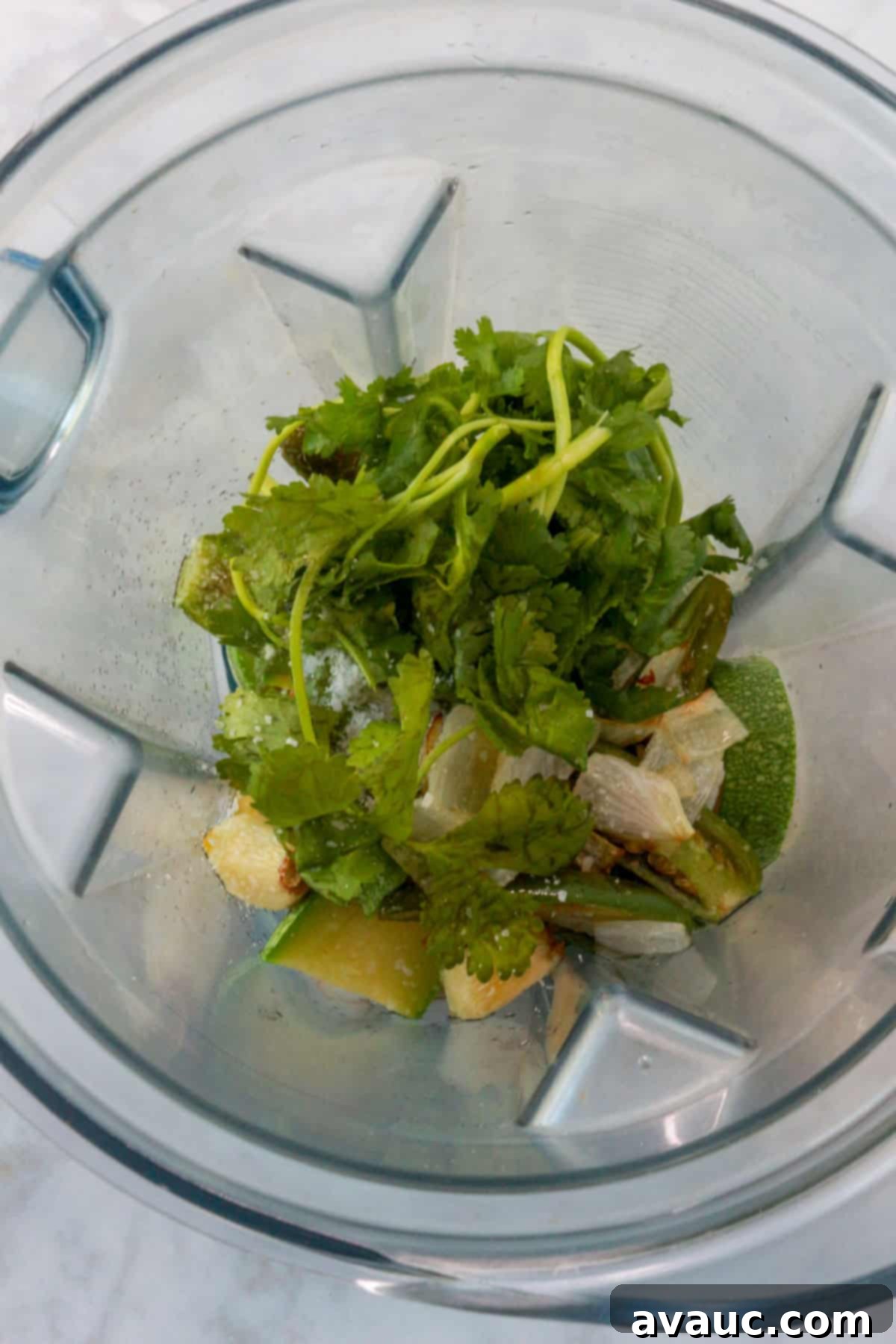 Mockamole 8 All Guacamole falso ingredients including parboiled tomatillos, zucchini, sautéed vegetables, cilantro, and salt, in a blender
