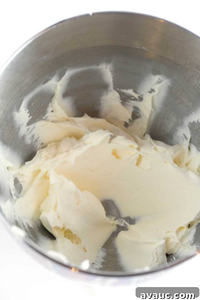 Velvet Smooth Sugar Cookie Icing 5 Mixing softened butter and cream cheese in a bowl for sugar cookie frosting.
