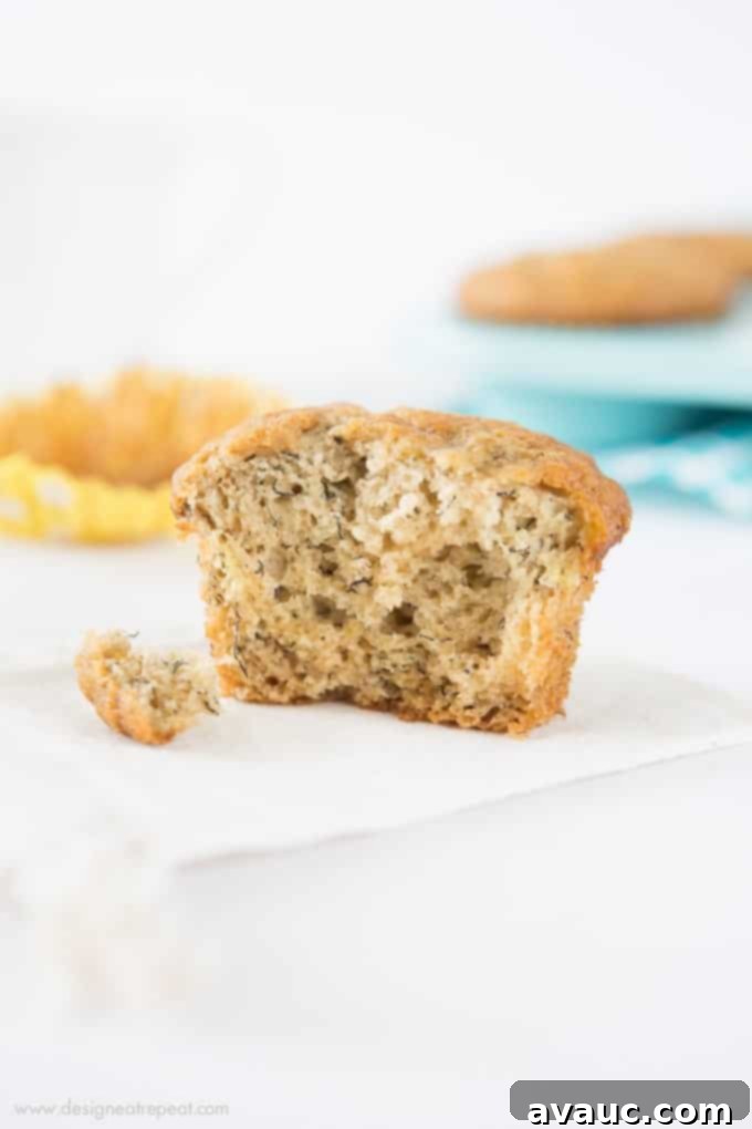 Freshly baked banana muffins, still warm in colorful cupcake liners, bringing a pop of joy to a quiet Sunday morning.
