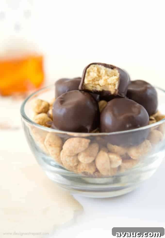 Effortless Peanut Butter Treats 5 A stack of finished no-bake peanut butter bites, coated in chocolate and ready to enjoy, highlighting their delicious appeal.