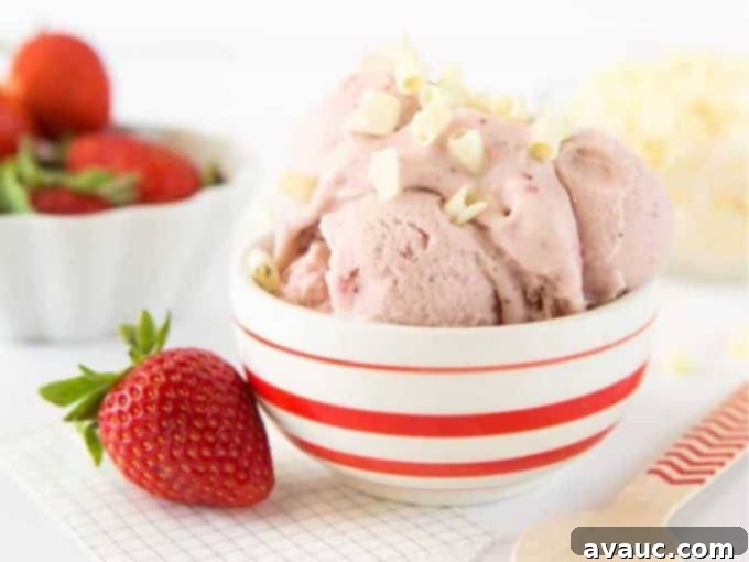 Strawberry Cake Batter Gelato in a bowl with a spoon, showing a soft, scoopable texture.