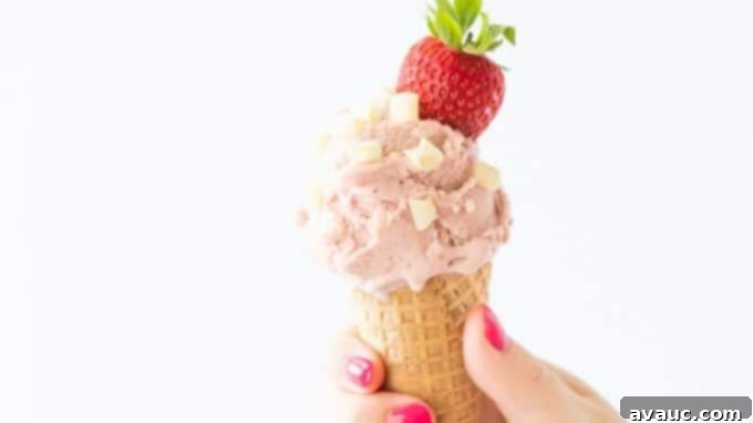 Two bowls of Strawberry Cake Batter Gelato side-by-side, garnished with fresh strawberries.