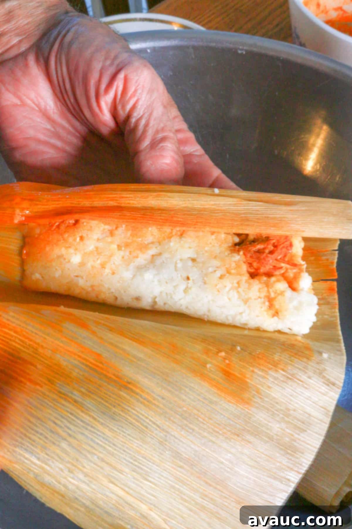 Red Chile Pork Tamales 14 Unwrapping a red chile pork tamal to check for doneness