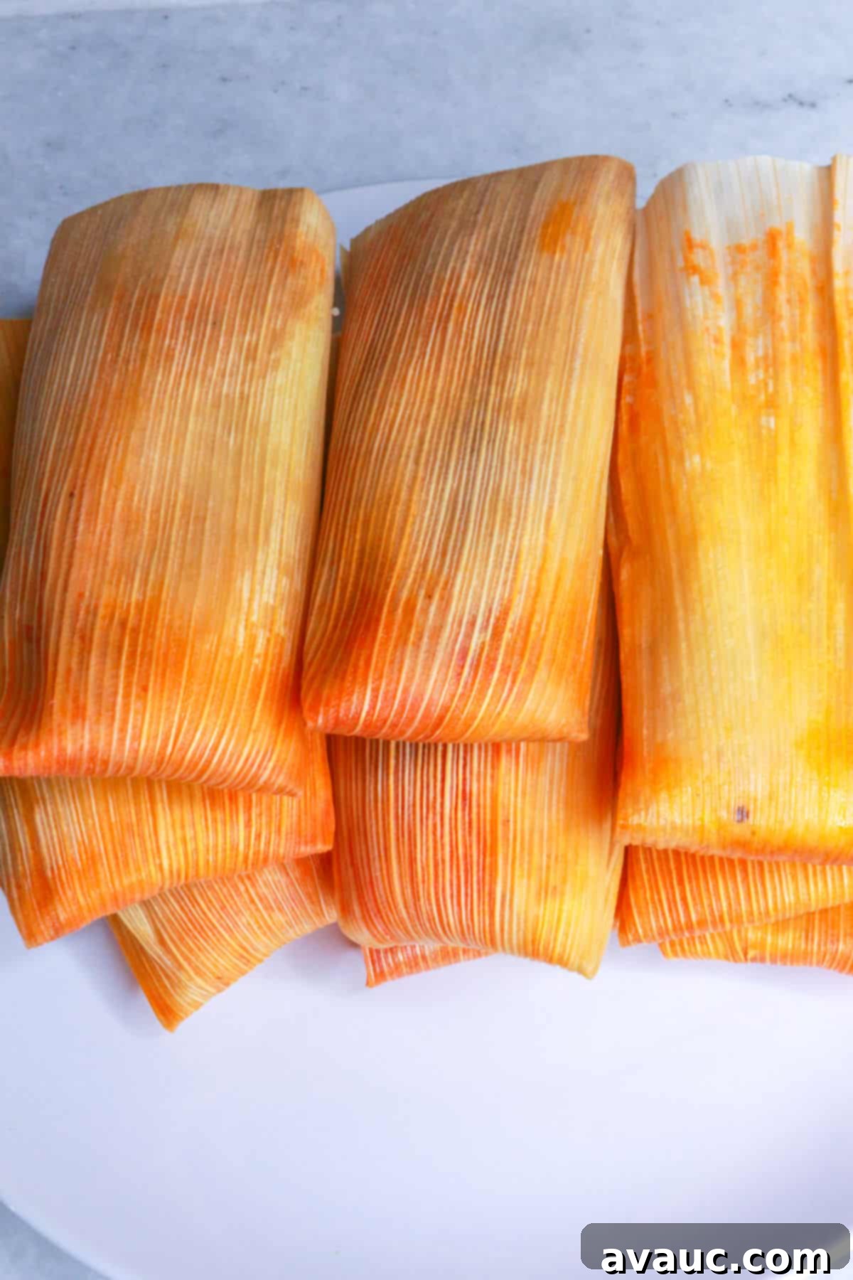 Red Chile Pork Tamales 15 Stacked tamales rojos on a plate