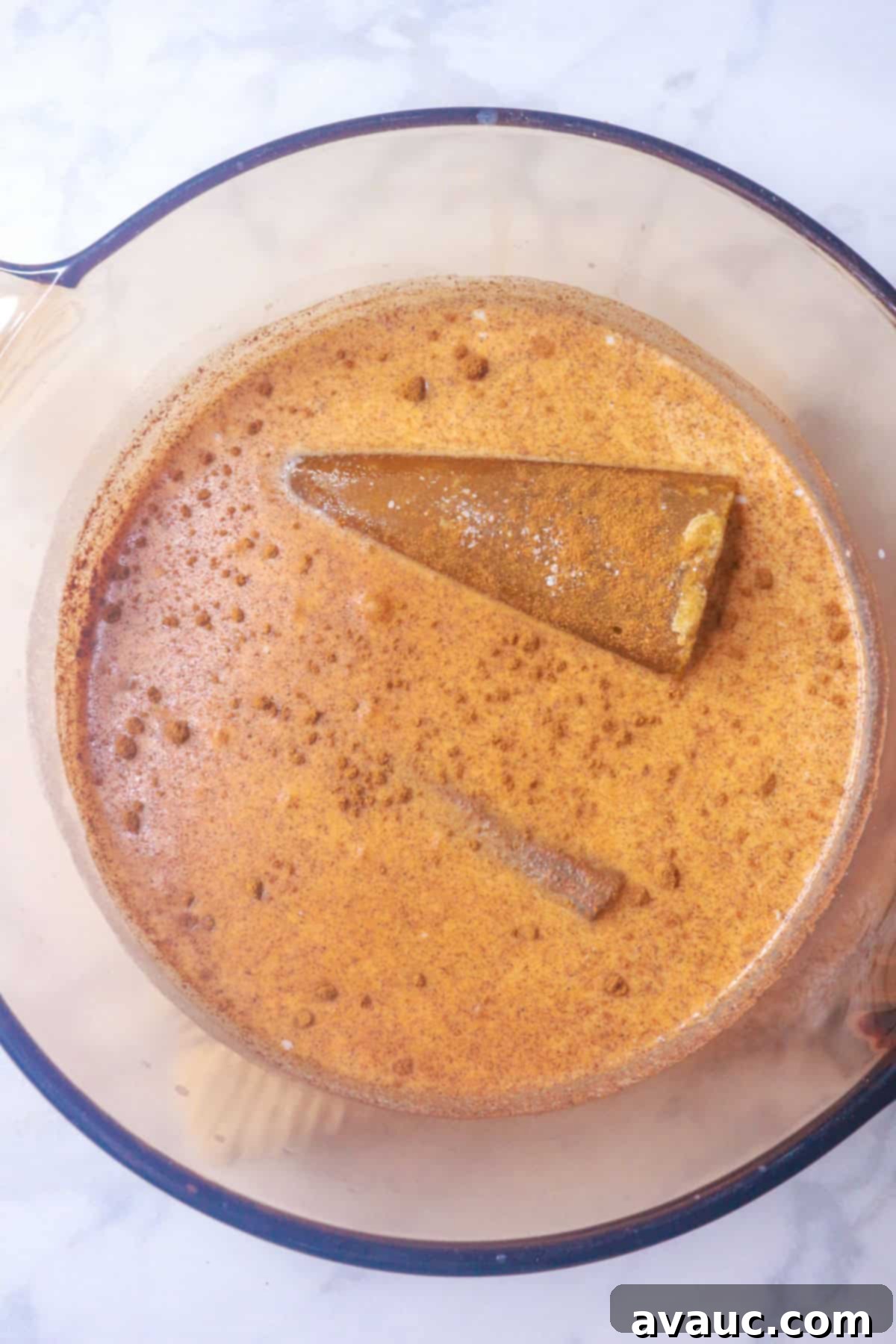 Milk, cinnamon stick, pumpkin spice and rice in a pot