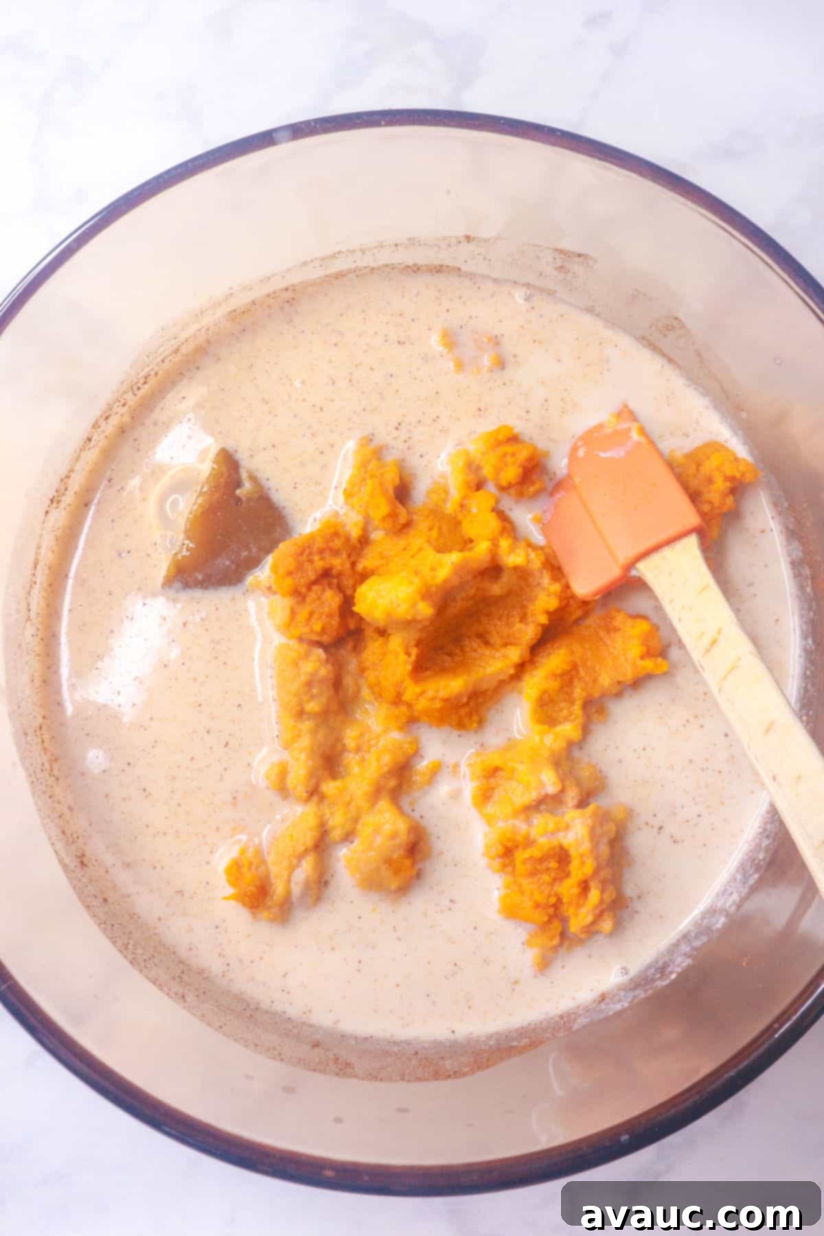 Added pumpkin puree to rice pudding mixture in a small pot