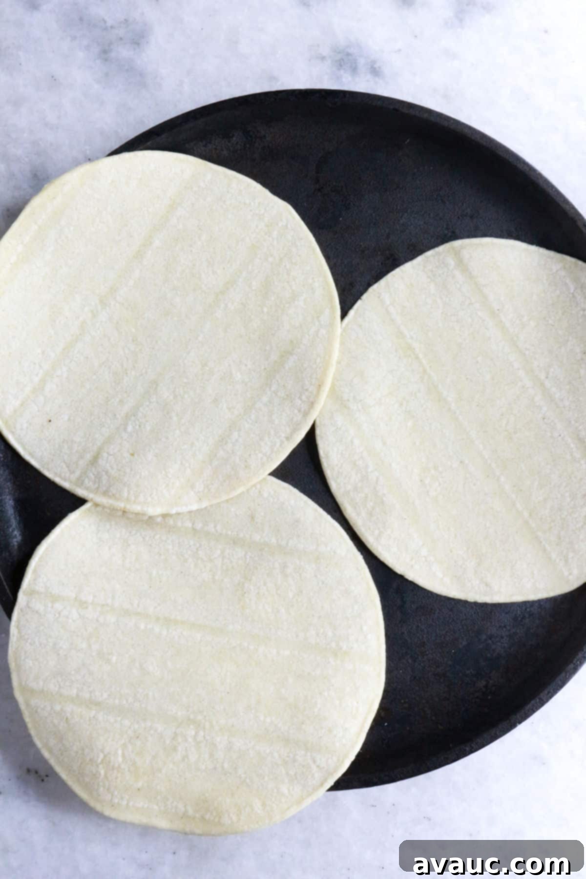 Crispy Rolled Chicken Tacos 4 3 corn tortillas on a griddle