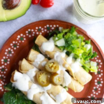 Crispy Rolled Chicken Tacos 10 Plate with 4 flautas on top of a bed of lettuce and smothered with jalapeño sour cream