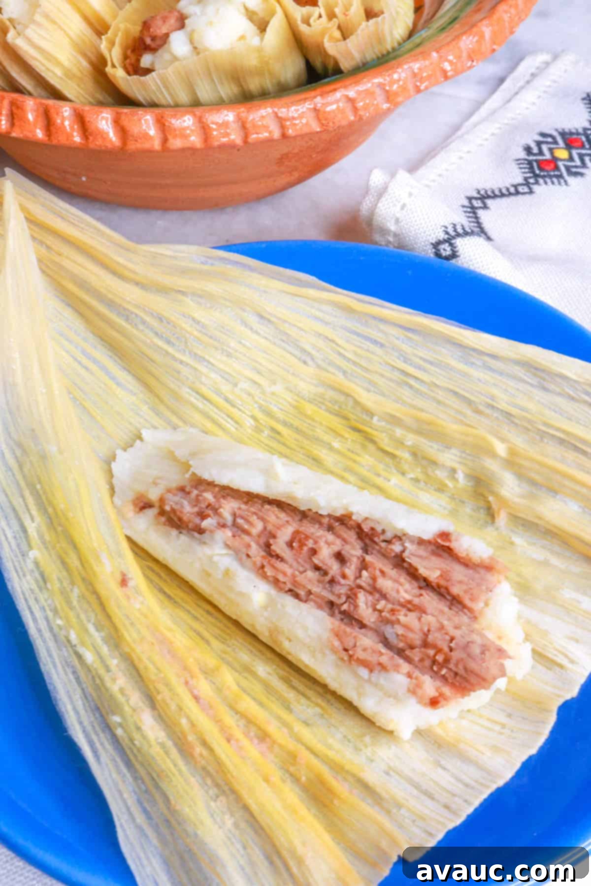Savory Refried Bean Tamales 15 Tamales de Frijol, with a close-up of one open bean tamal on a blue plate