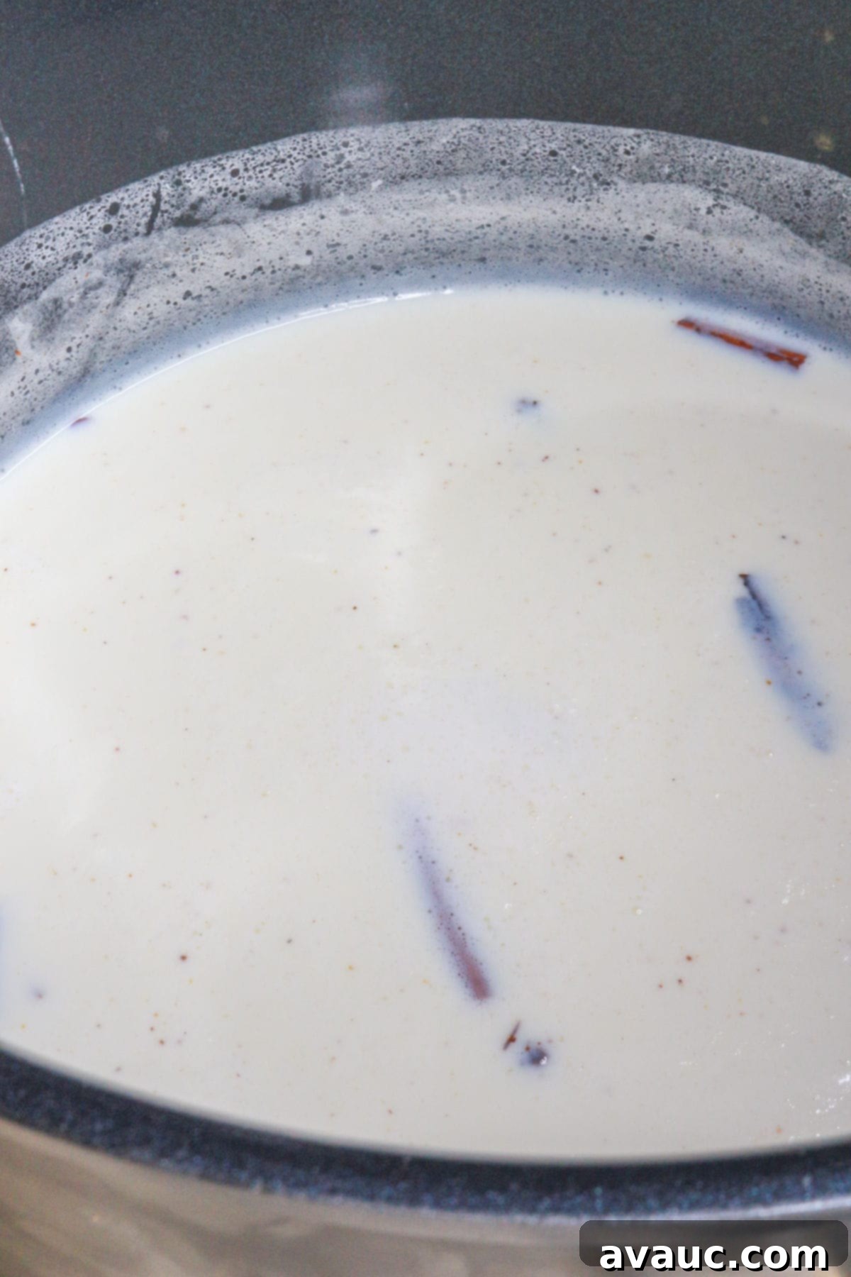 Rompope Mexicos Creamy Eggnog 5 Cinnamon sticks and other spices in milk in a large pot, simmering gently