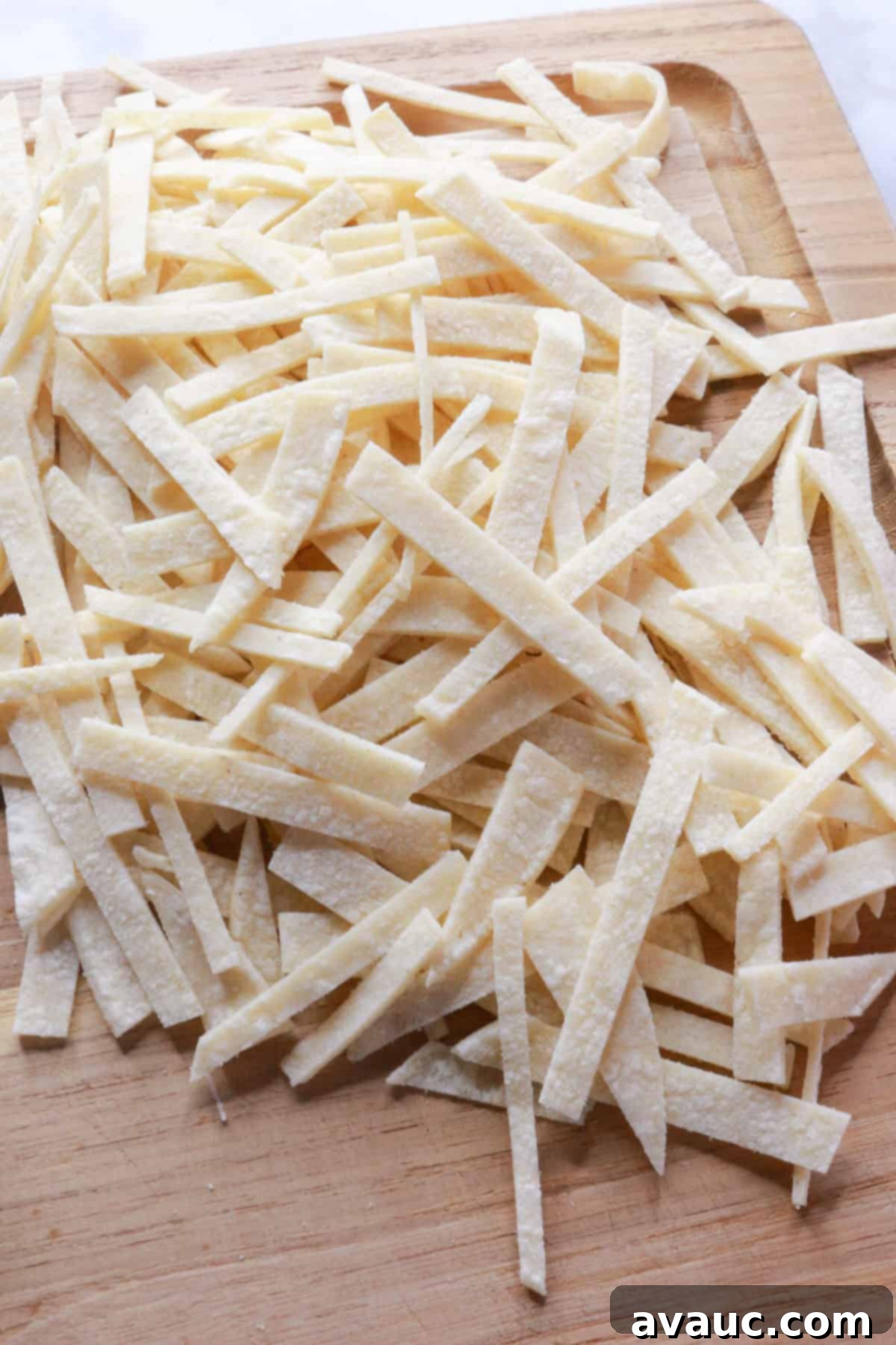 Hearty Poblano Soup: Dairy-Free Creaminess 5 Tortilla strips on a cutting board