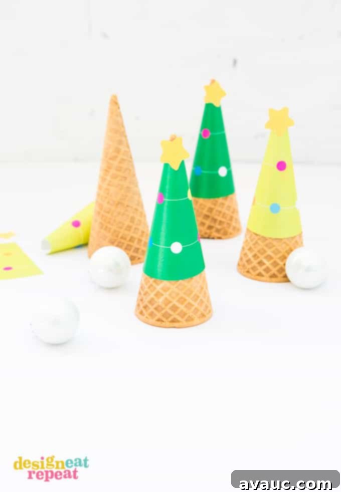 Printable Christmas Tree Cone Decorations 4 Close-up of printed Christmas tree ice cream cone wrapper template being carefully cut with scissors on a wooden surface