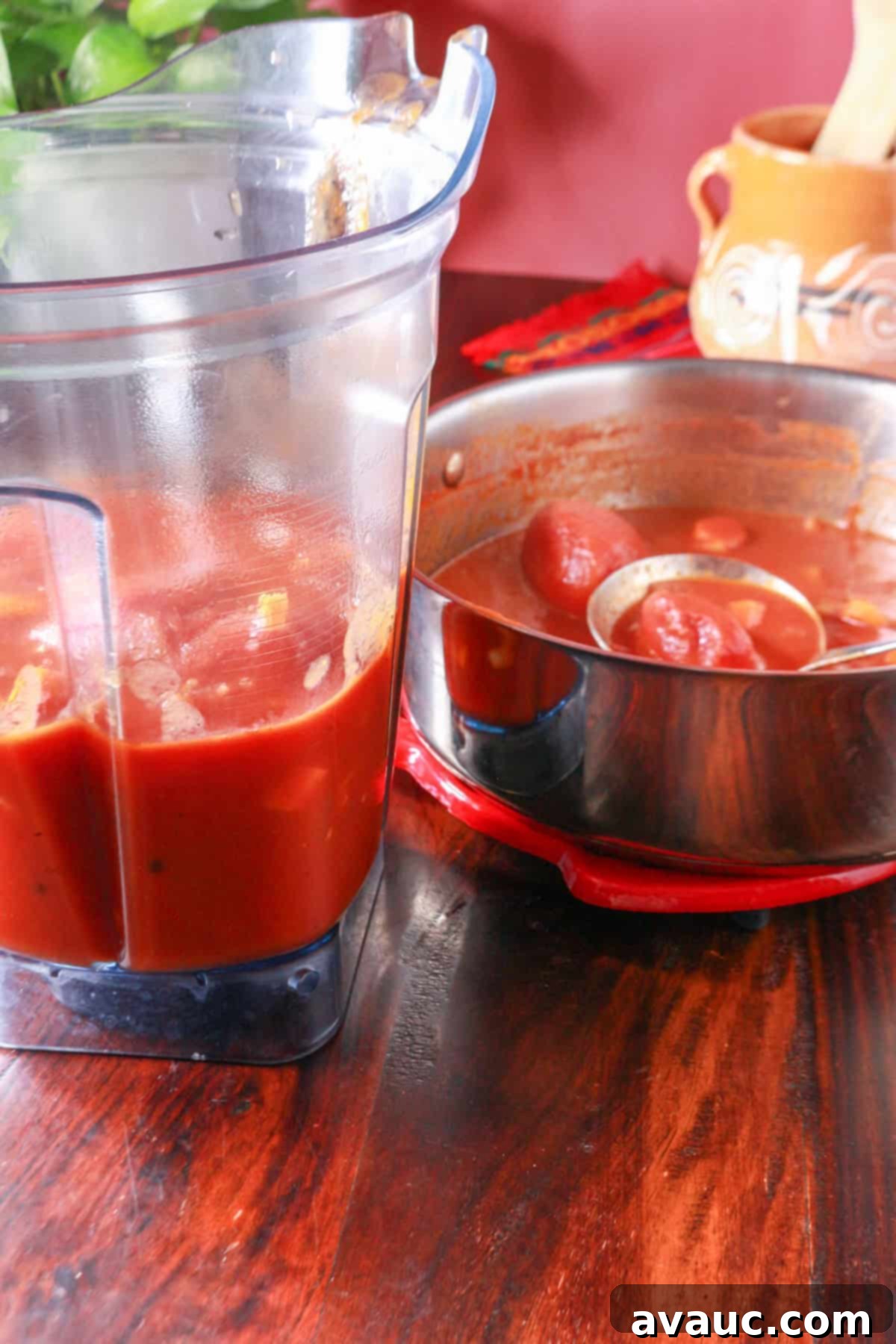 Spiced Chipotle Tomato Soup with Garlic Croutons 6 A blender with ingredients for the soup beside a pot with the rest of the ingredients