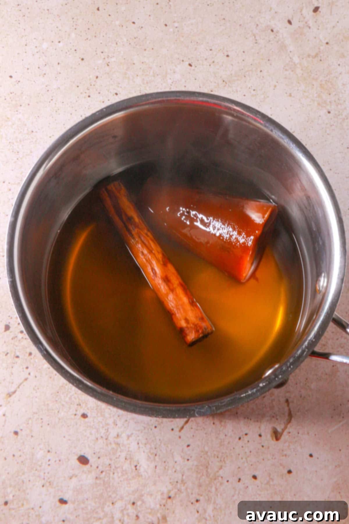 Dairy-Free Atole de Nuez 4 Cinnamon stick and piloncillo in a pot with water