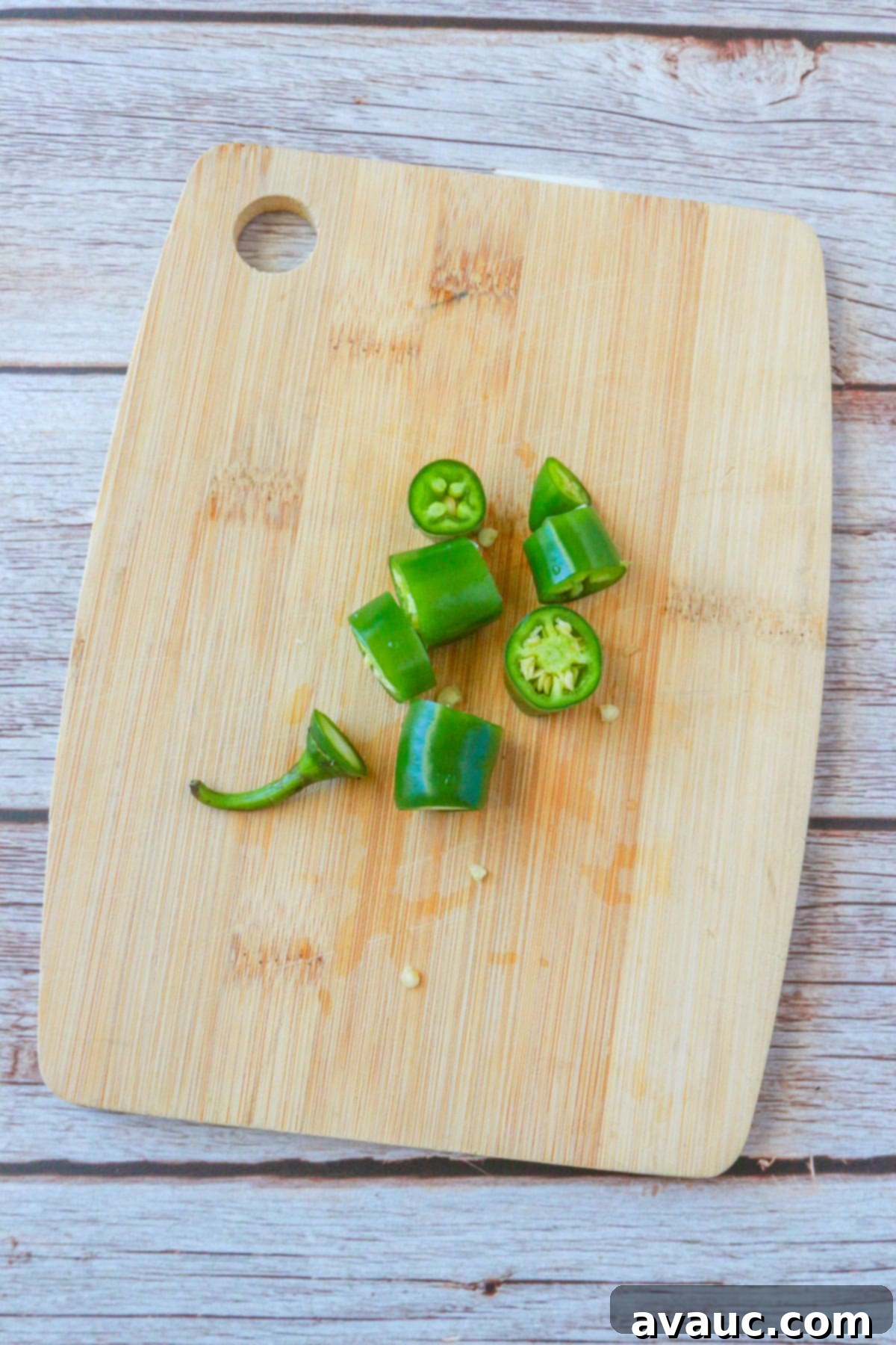 Vegan Creamy Serrano Ranch 4 Fresh serrano peppers, finely chopped on a cutting board, ready for blending into the creamy ranch dressing.