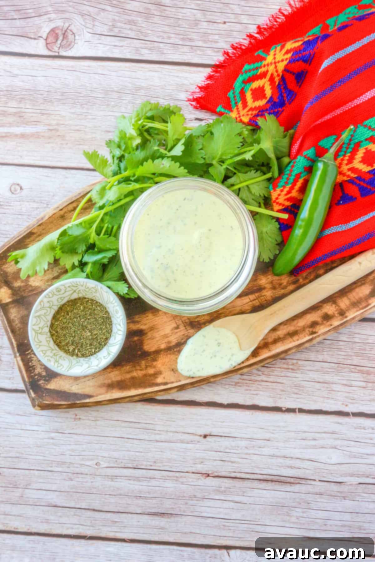 Vegan Creamy Serrano Ranch 7 A close-up, top-down view of the freshly blended spicy serrano ranch dressing in a bowl, showcasing its smooth, creamy texture and vibrant color.