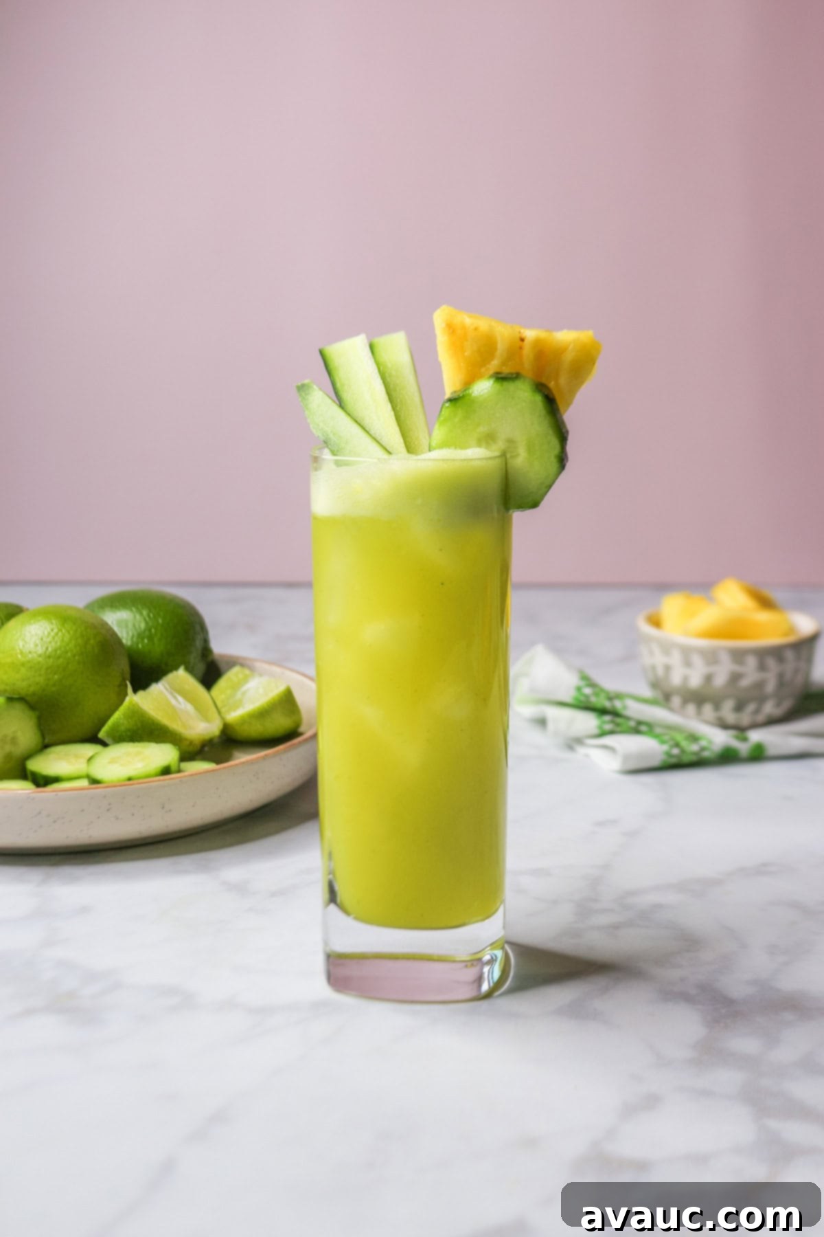 Crisp Pineapple Cucumber Agua Fresca 11 Close-up of a glass of pineapple cucumber agua fresca garnished with fresh pineapple and cucumber pieces, ready to be enjoyed