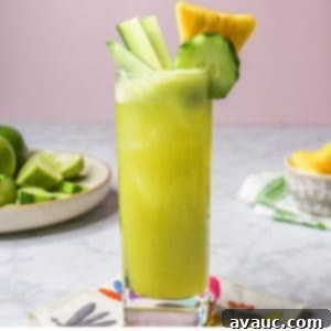 Crisp Pineapple Cucumber Agua Fresca 13 Pineapple cucumber agua fresca in a tall glass on a Mexican-style coaster