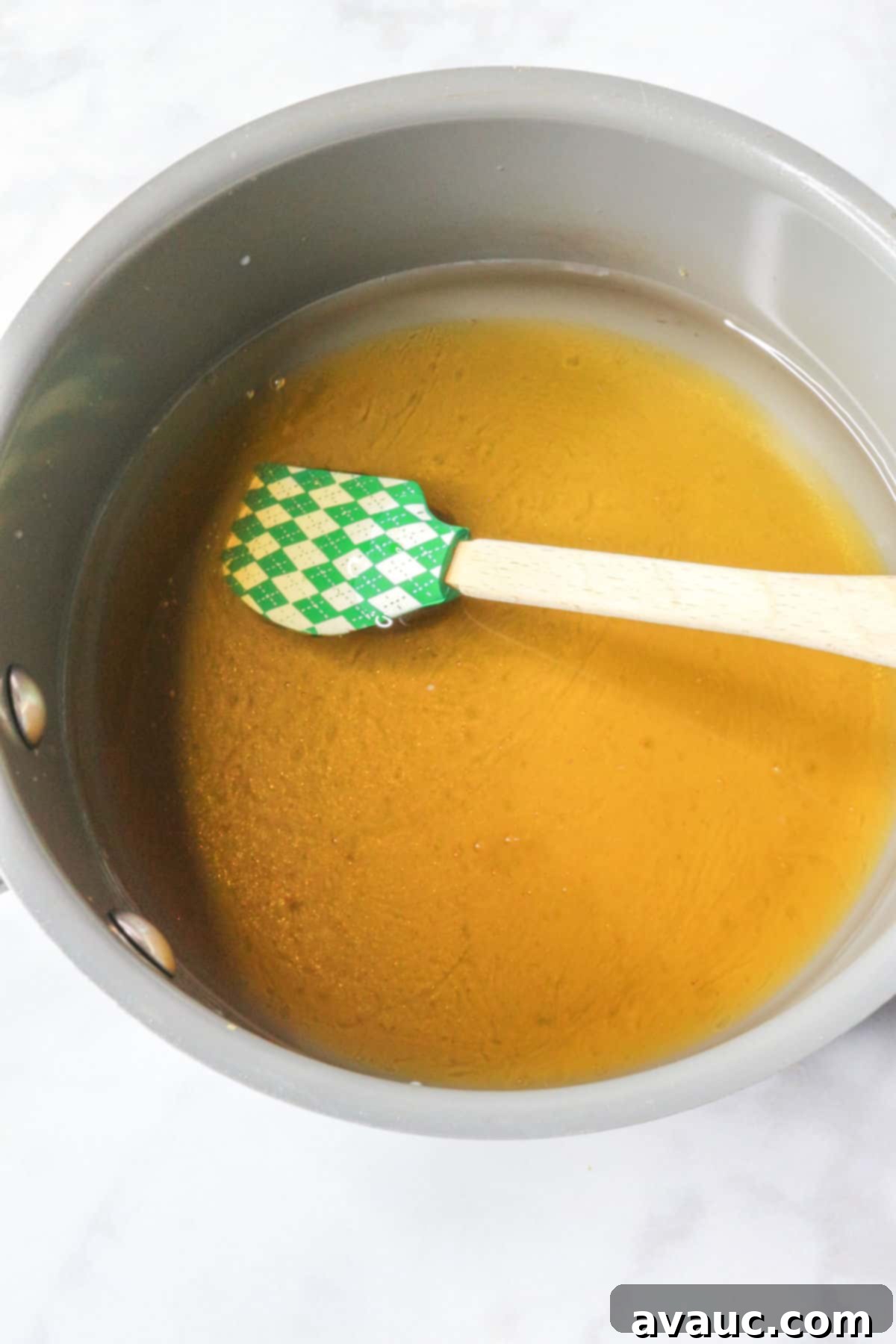 Crisp Pineapple Cucumber Agua Fresca 4 Saucepan with honey simple syrup simmering gently on the stove