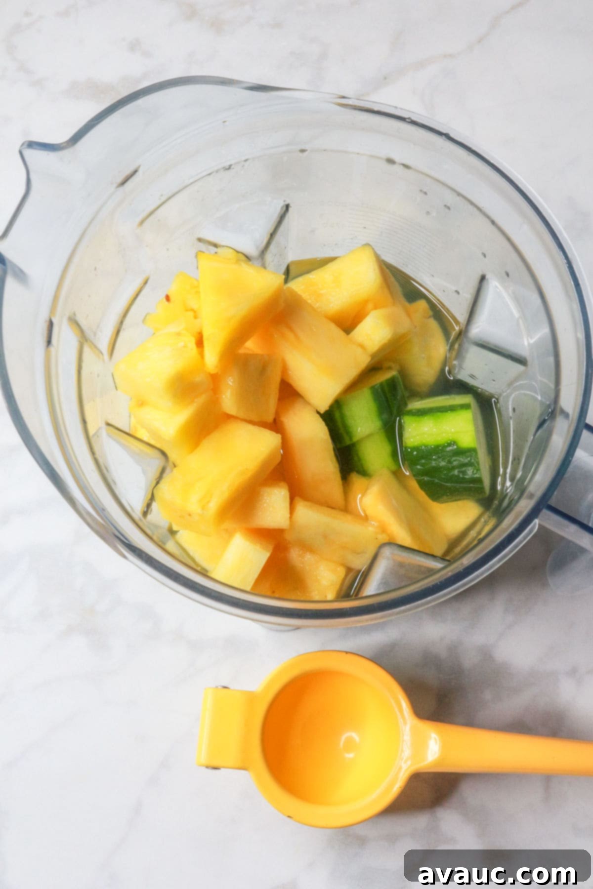 Crisp Pineapple Cucumber Agua Fresca 7 Blender filled with vibrant pieces of pineapple and cucumber, ready to be blended
