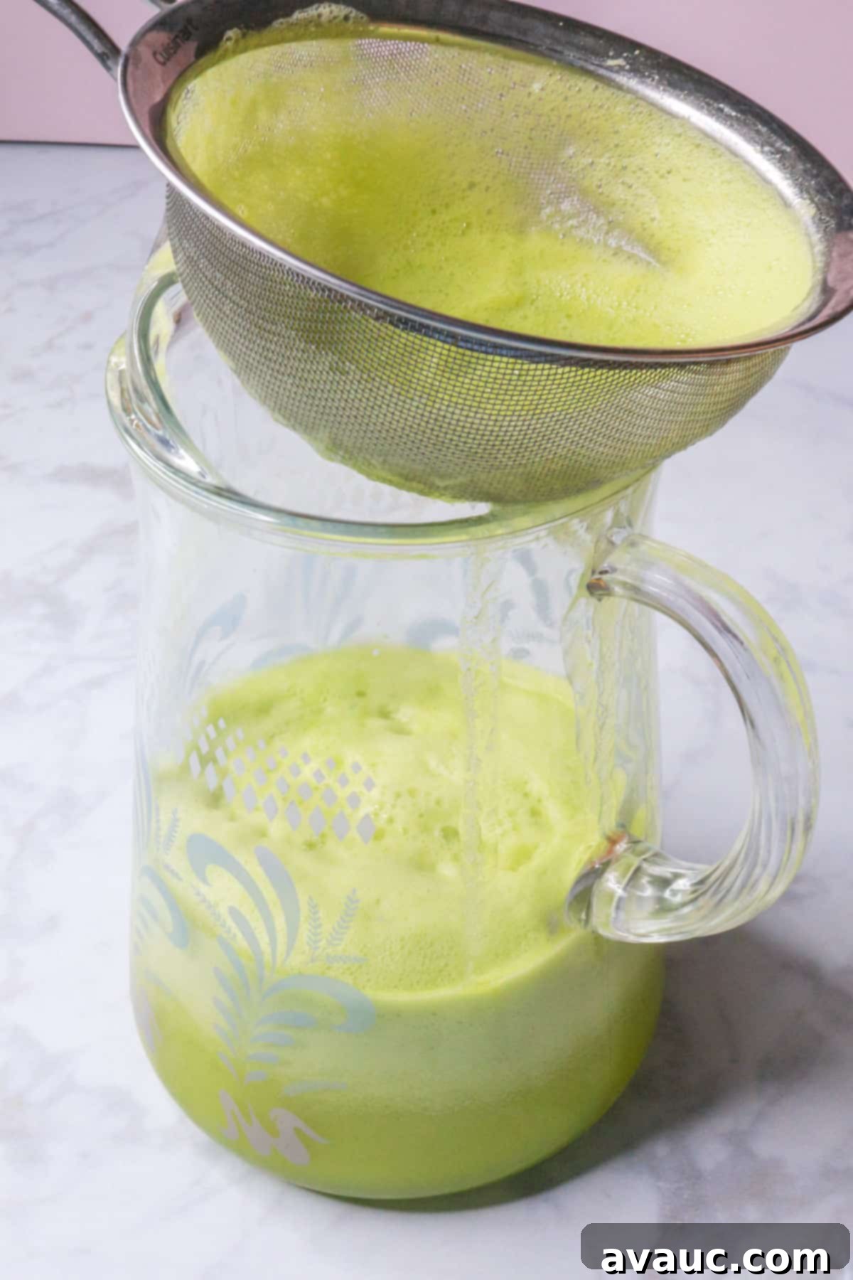 Crisp Pineapple Cucumber Agua Fresca 8 Straining the blended pineapple cucumber mixture through a fine-mesh sieve into a large glass pitcher
