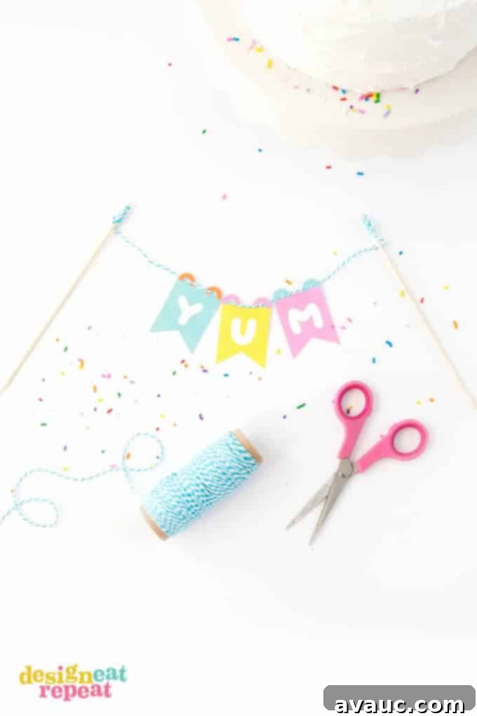 Close-up of the DIY printable cake topper banner's colorful pennants and baker's twine, showcasing the clean lines and bright hues.