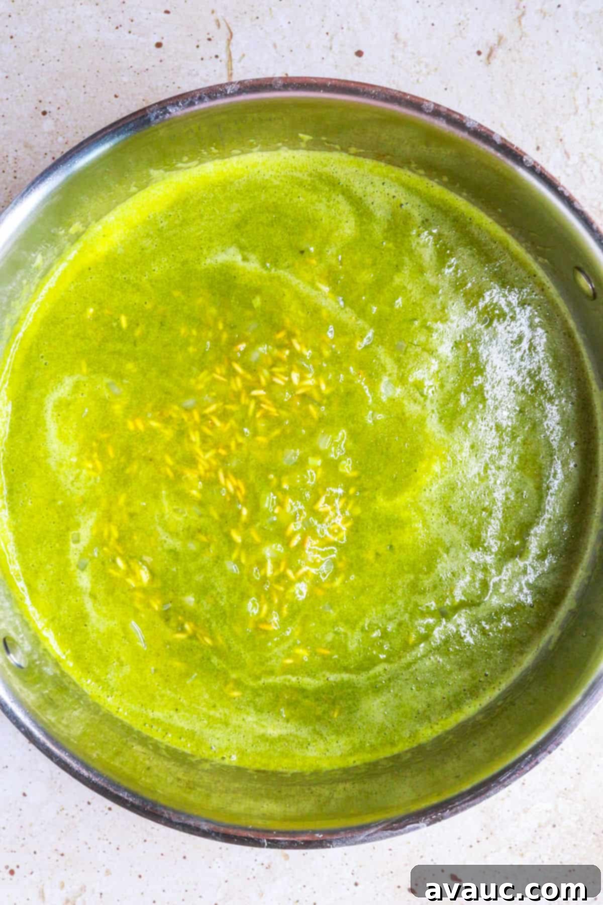 Rice in a pan covered with poblano sauce