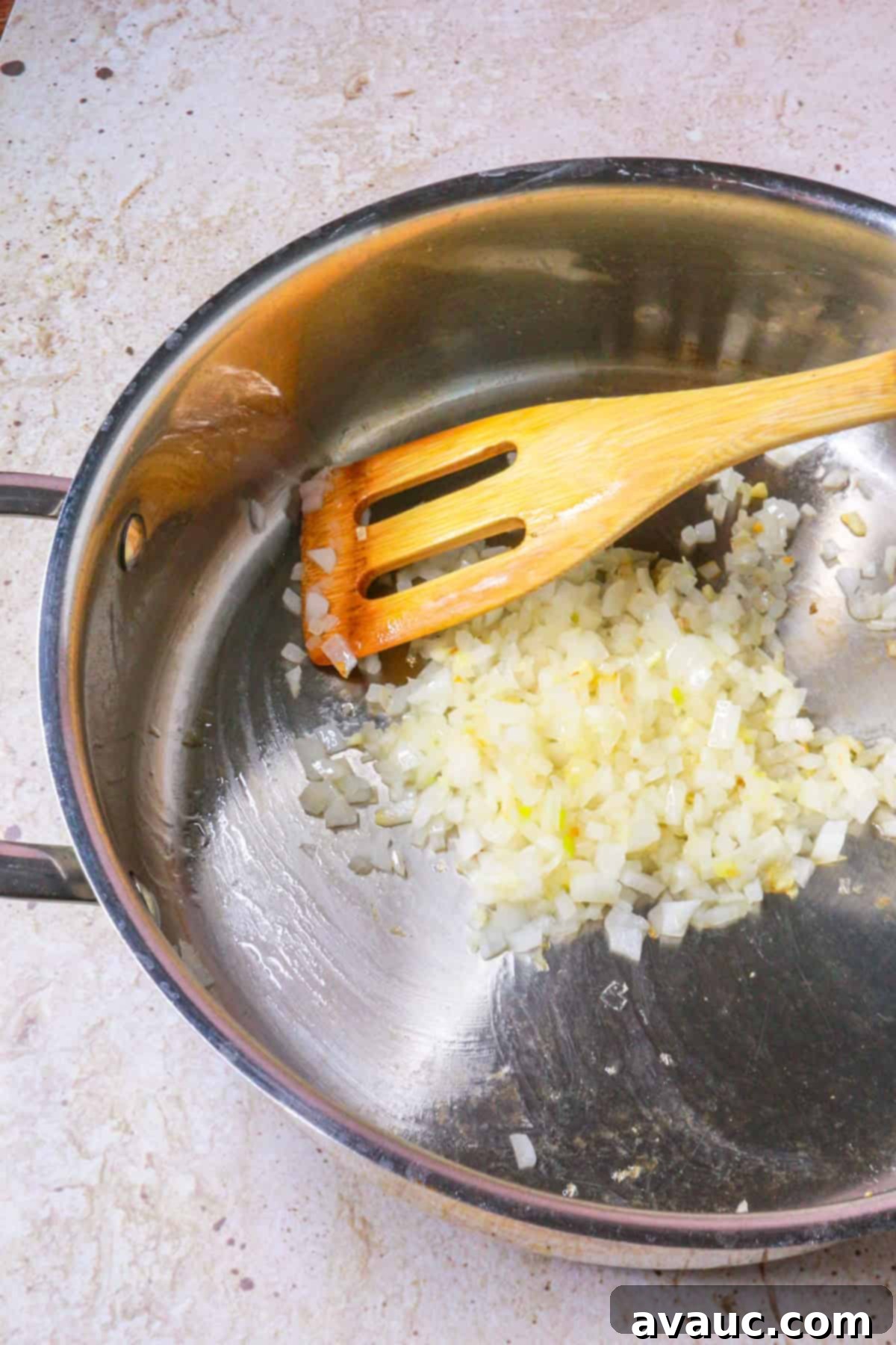 Sautéing diced garlic and onion in a pan