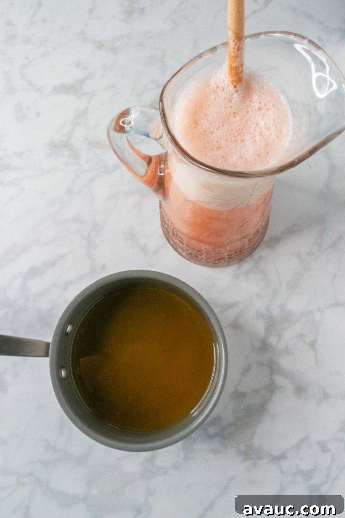 Pineapple Strawberry Oasis 10 A small pot with honey simple syrup and a glass pitcher with agua de piña y fresa