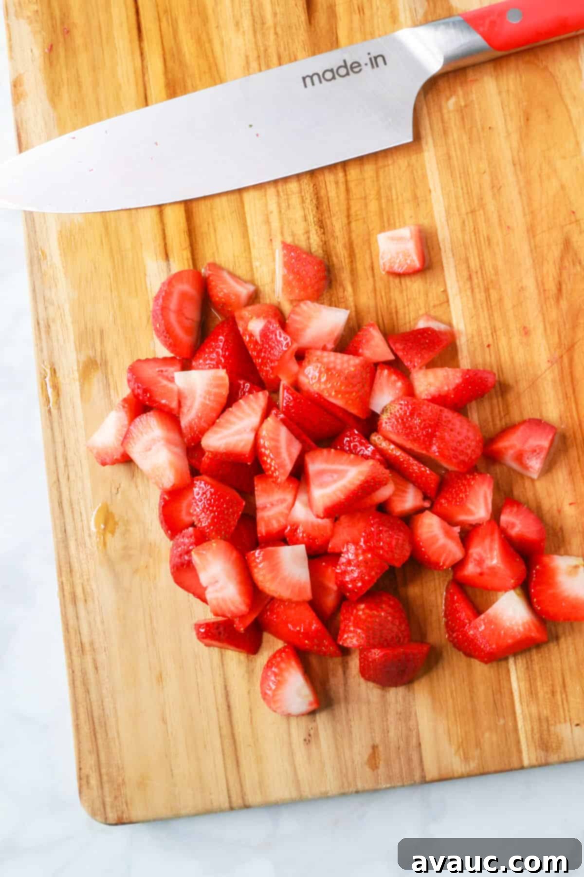 Pineapple Strawberry Oasis 6 Chopped strawberries on a cutting board