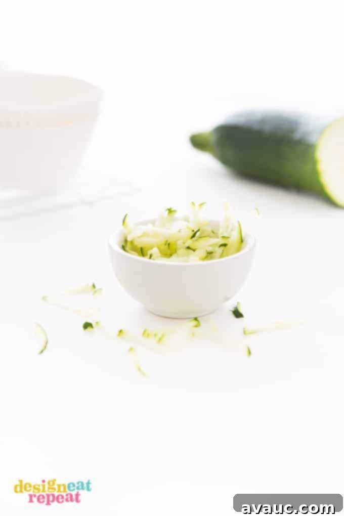 Small white bowl of shredded Zucchini.