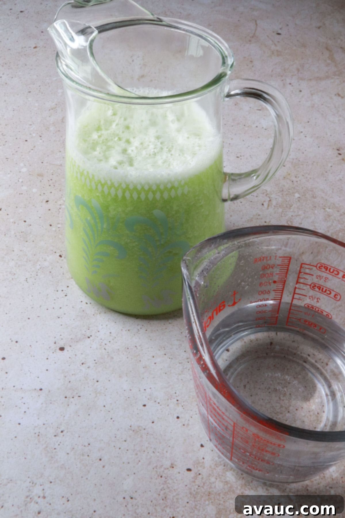 Honeydew Mint Agua Fresca 8 Pitcher of agua fresca and a measuring cup with water