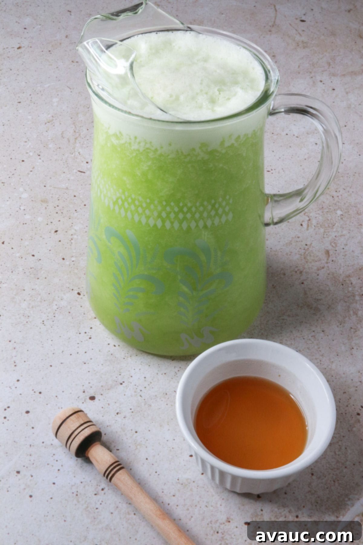 Honeydew Mint Agua Fresca 9 Pitcher of agua de melon verde and a small bowl with honey simple syrup