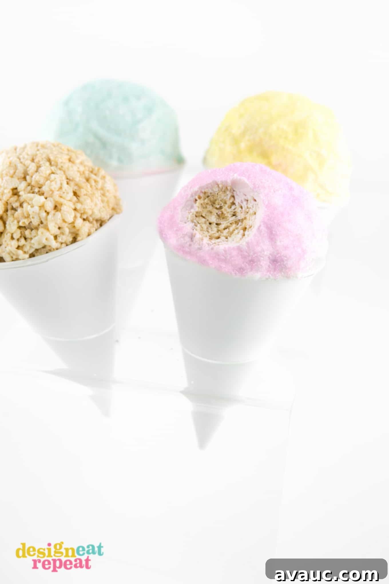 Close-up of a pink Rice Krispies Snow Cone with a bite taken, showcasing its gooey texture.
