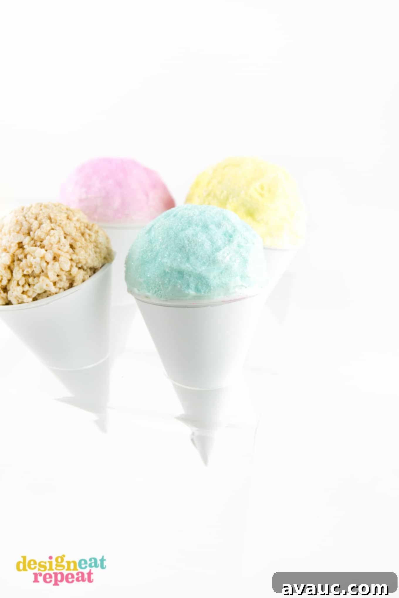 Finished Rice Krispies Snow Cones in an ice cream cone holder, showcasing various colored candy coatings and sprinkles.