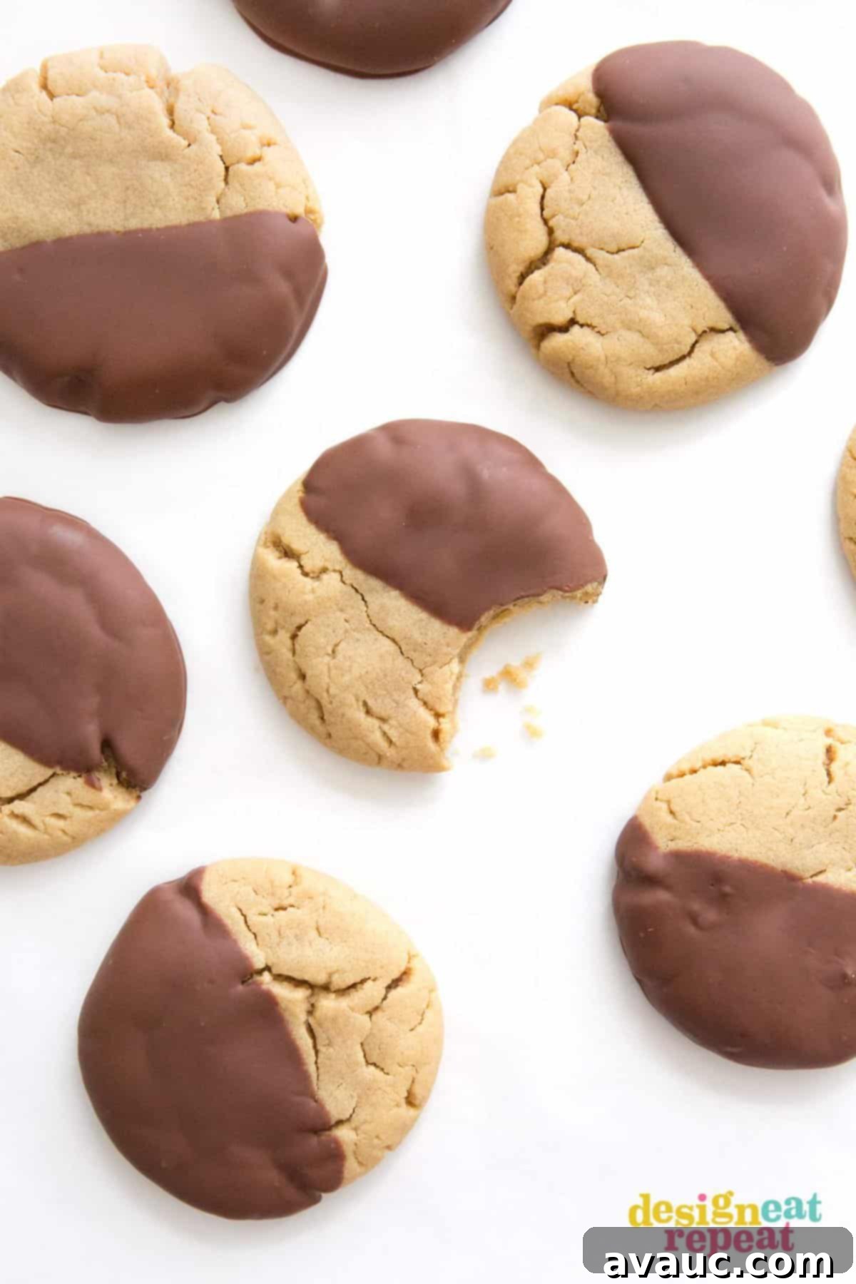 Large peanut butter cookies dipped in chocolate with bite.