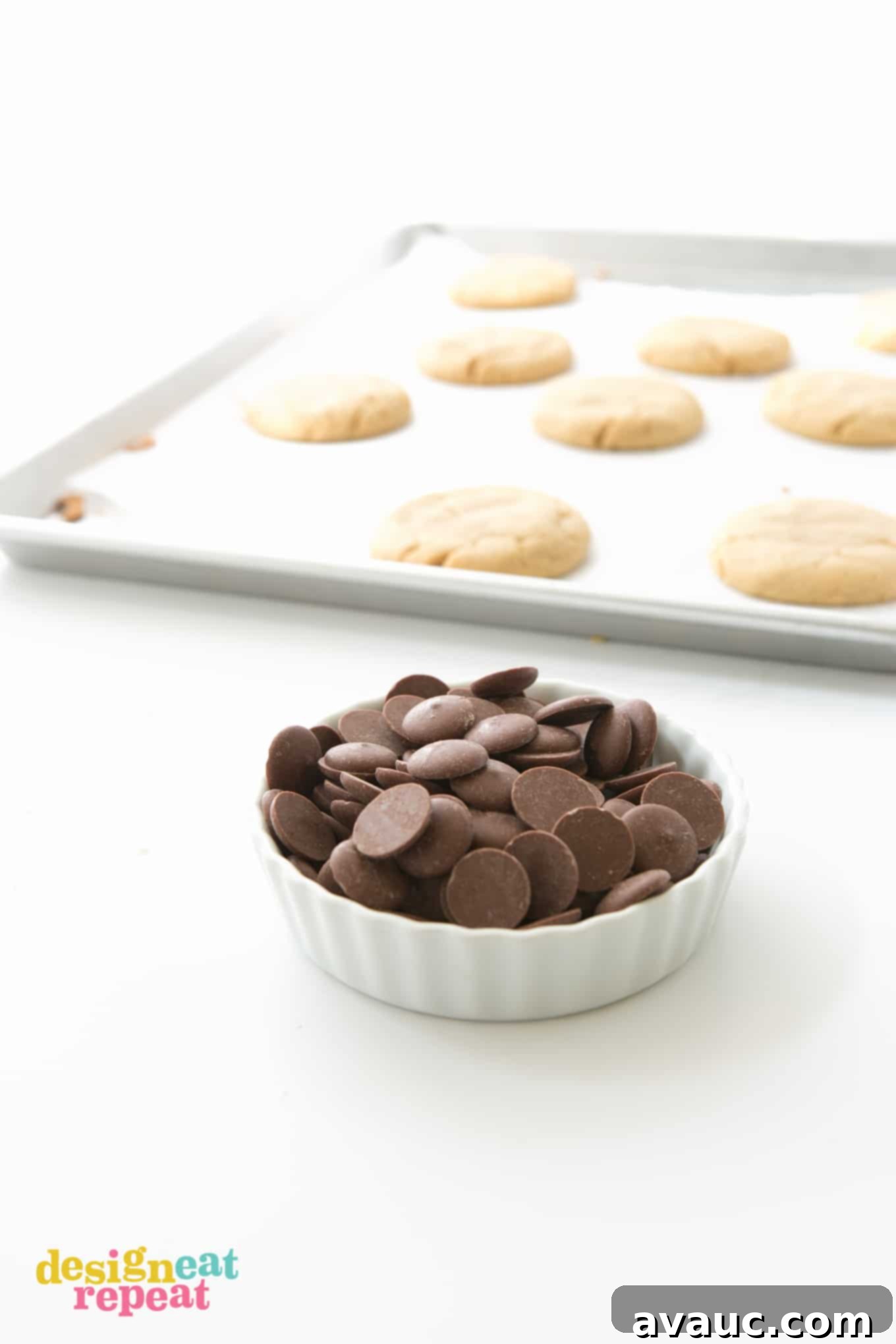 Bowl of dark chocolate melting wafers to use on peanut butter cookies.