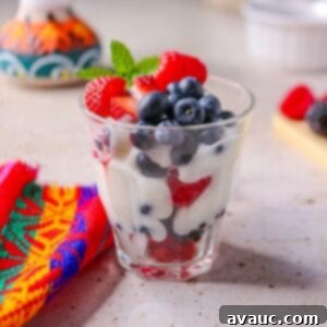 Luscious Dairy-Free Berries and Cream 10 Beautifully layered dairy-free berries with cream in a glass cup, ready to be enjoyed as a refreshing dessert.