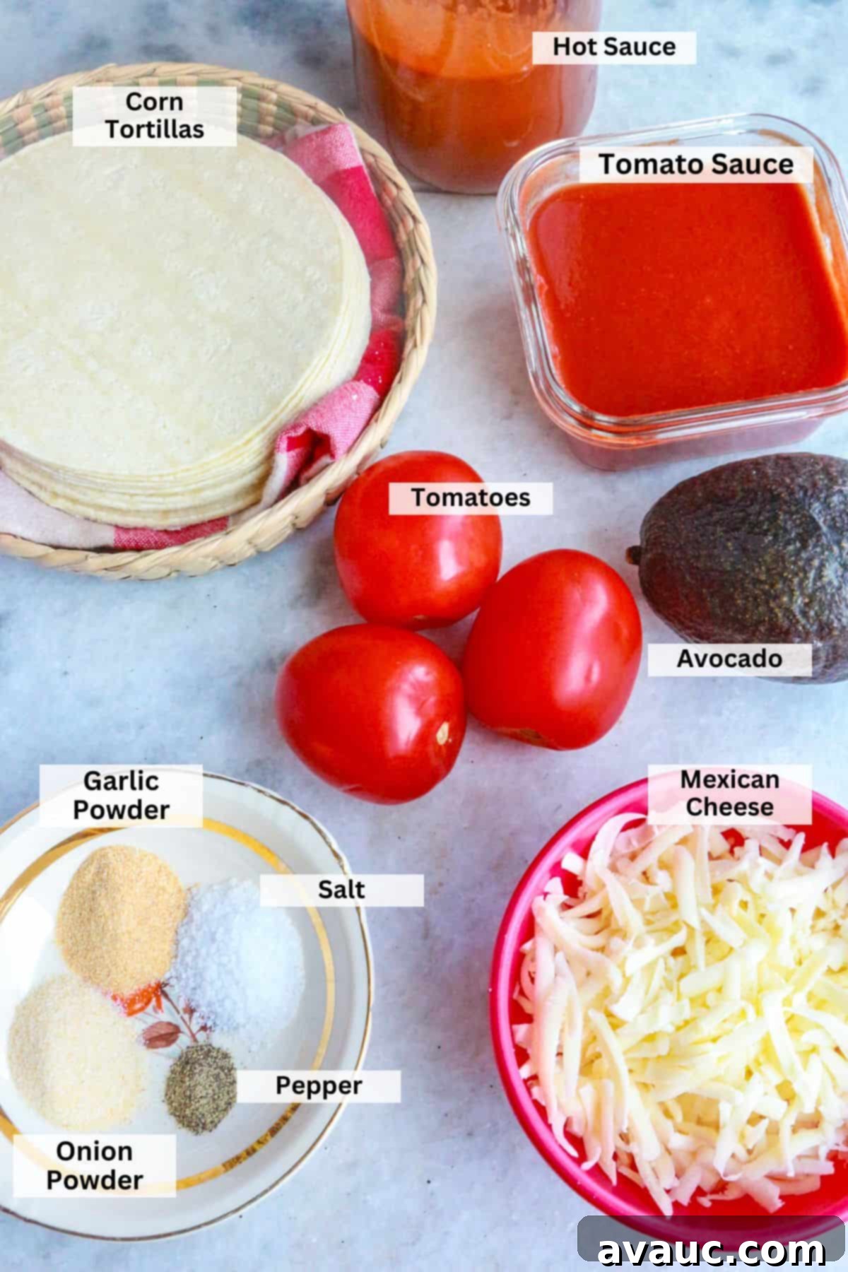 Aztec Tortilla Soup 3 Key ingredients for Sopa de Tortilla Azteca laid out: corn tortillas, tomato sauce, hot sauce, fresh Roma tomatoes, creamy avocado, shredded Mexican cheese, and a selection of aromatic spices.