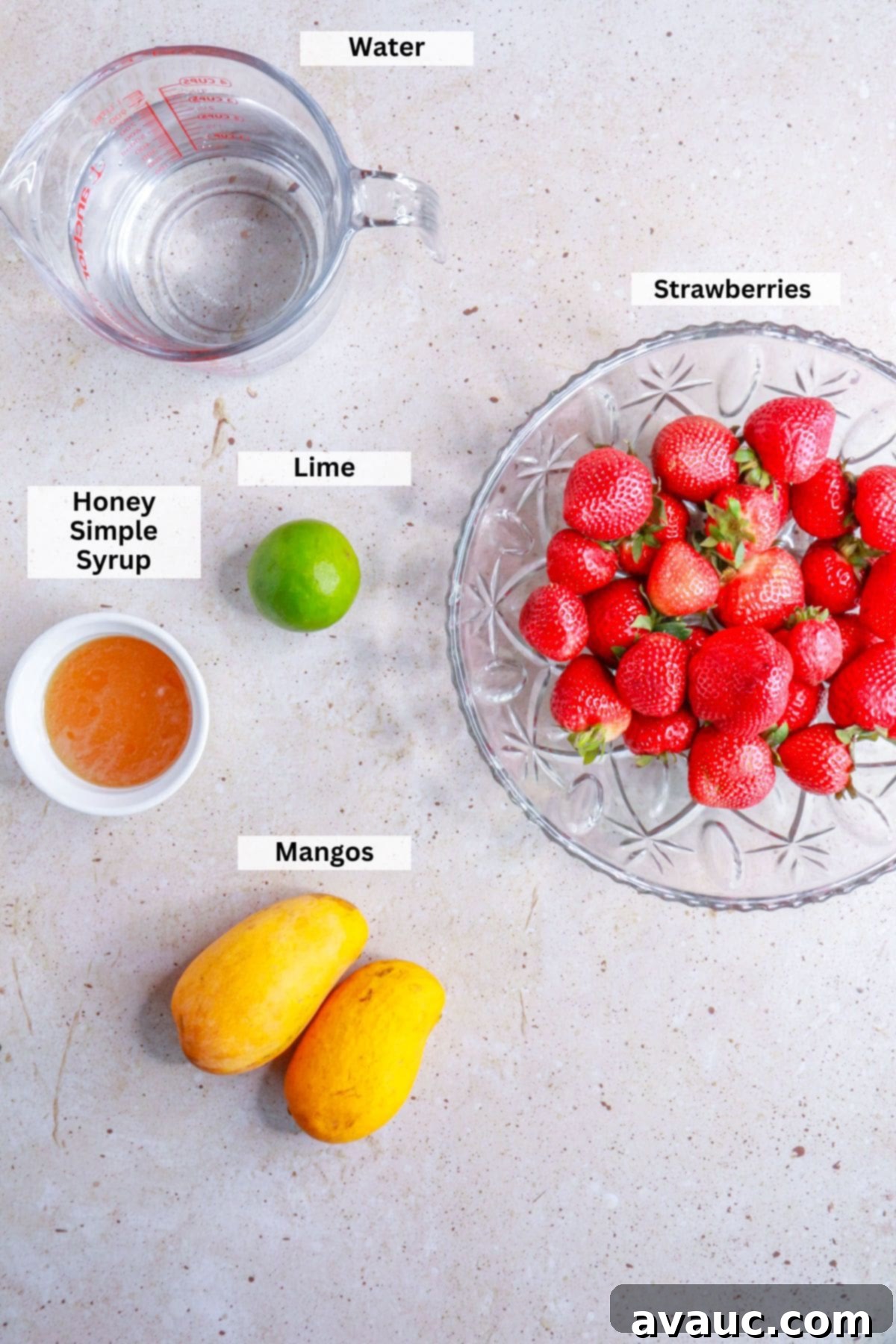 Ingredients for strawberry mango Agua Fresca: water, strawberries, lime, honey simple syrup, and mangos