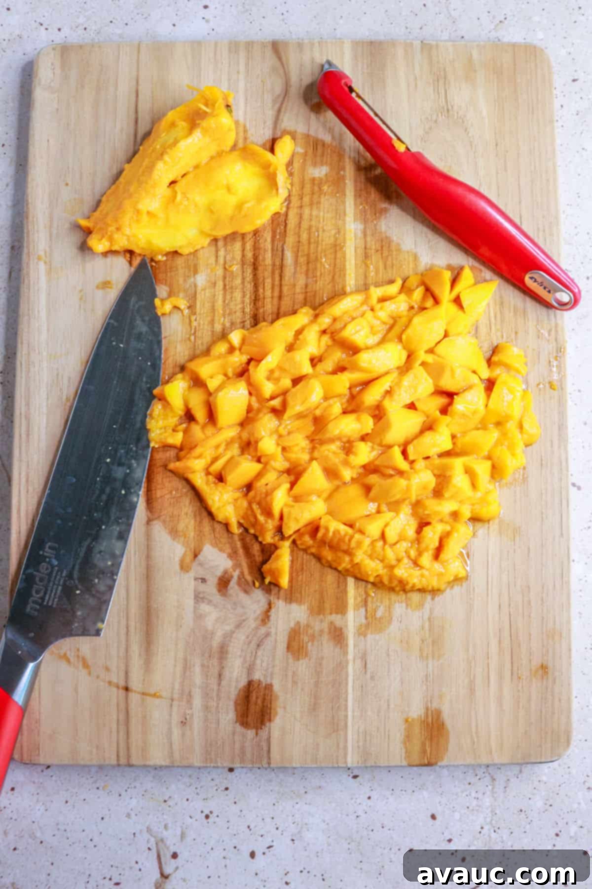 Chopped mangos on wooden cutting board