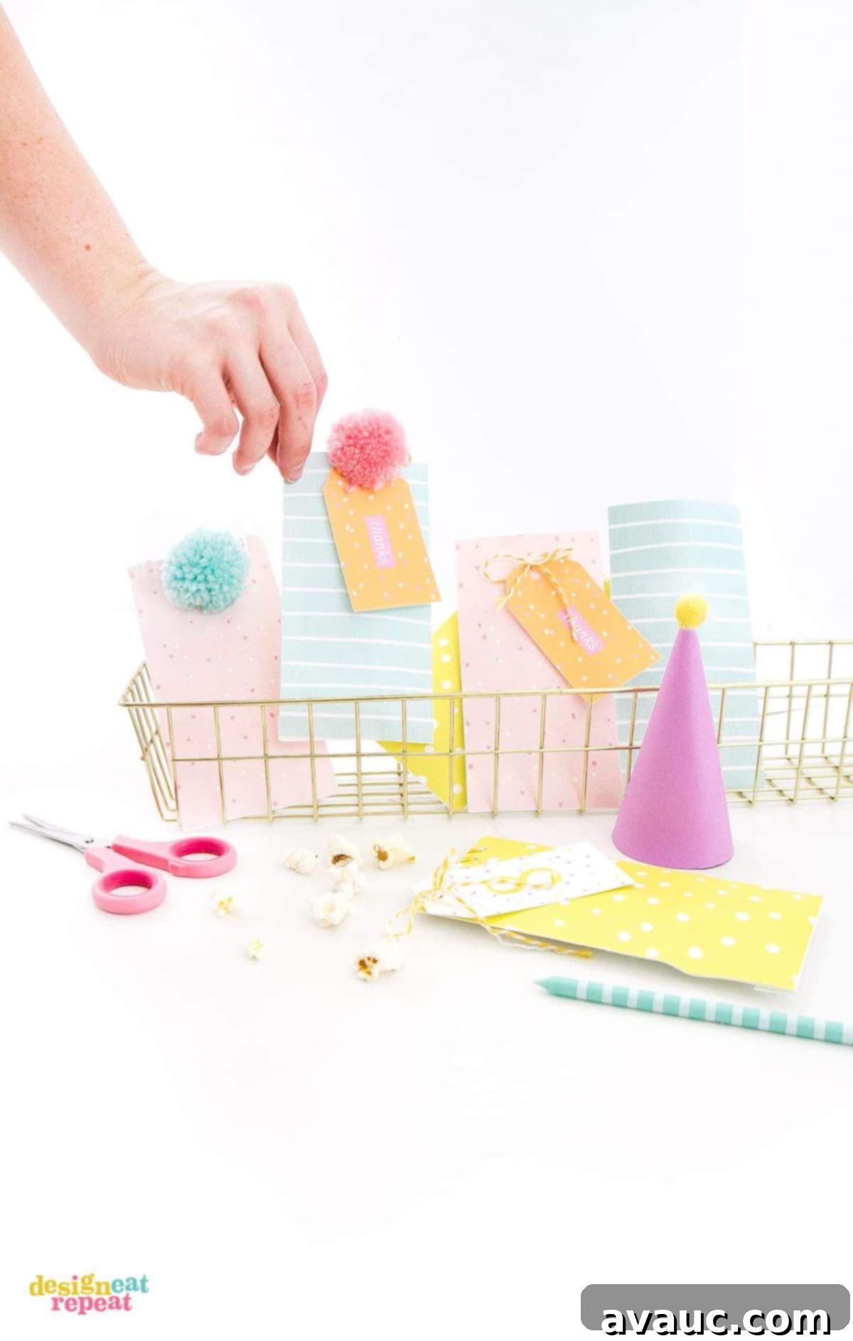 Basket of pink, peach, blue, and yellow party favor bags with matching printable gift tags.