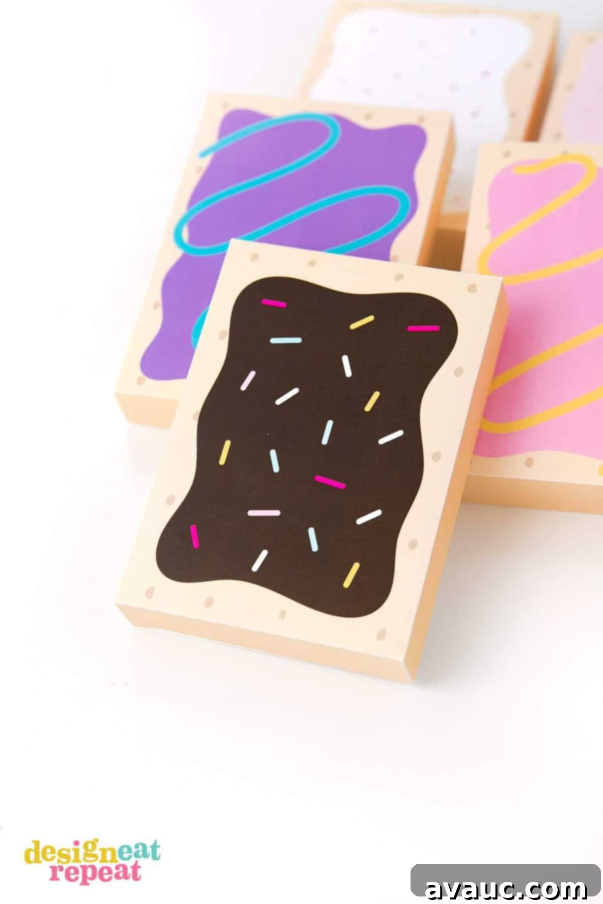Close-up of three assembled toaster pastry treat boxes with varying designs