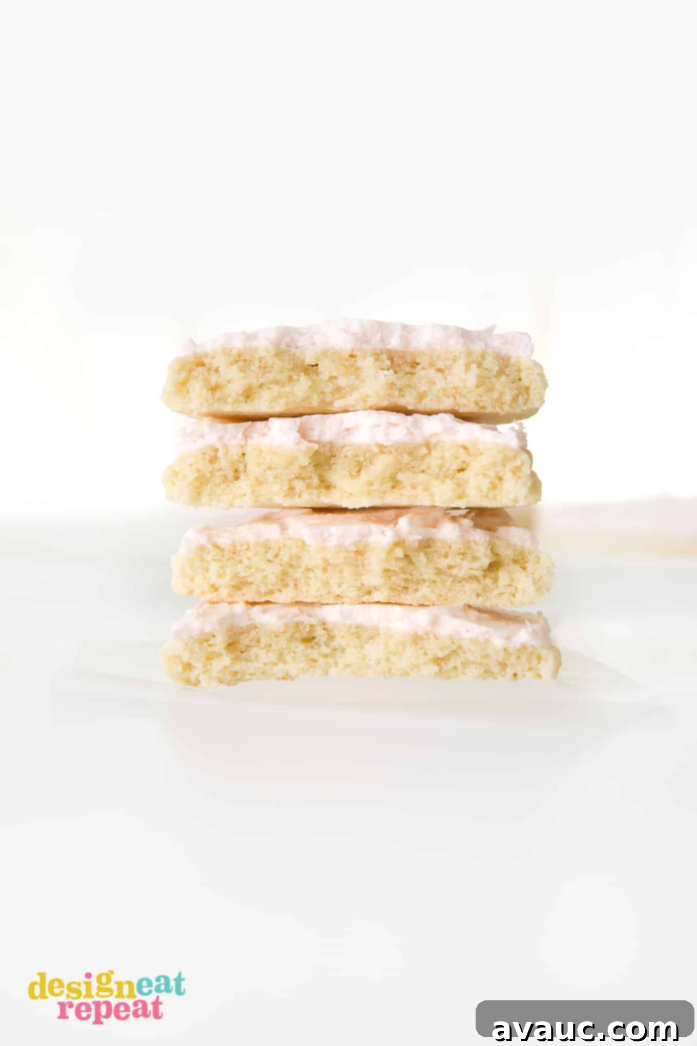 Blush Pink Sugar Clouds 2 Stack of four large, thick sugar cookies with vibrant pink frosting, two cut in half to show the soft interior.