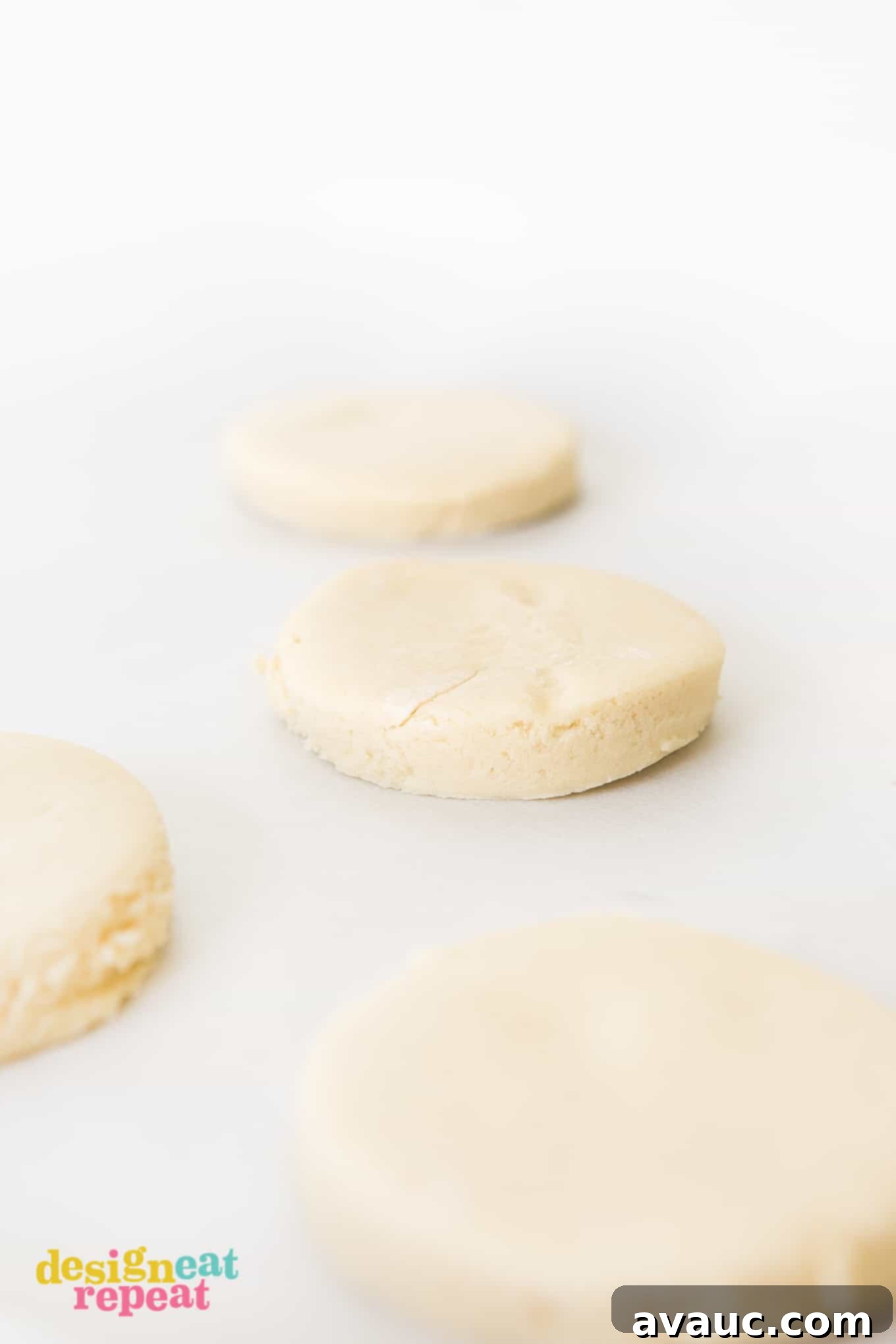 Blush Pink Sugar Clouds 5 Raw sugar cookie dough rolled out on parchment paper, ready for cutting.