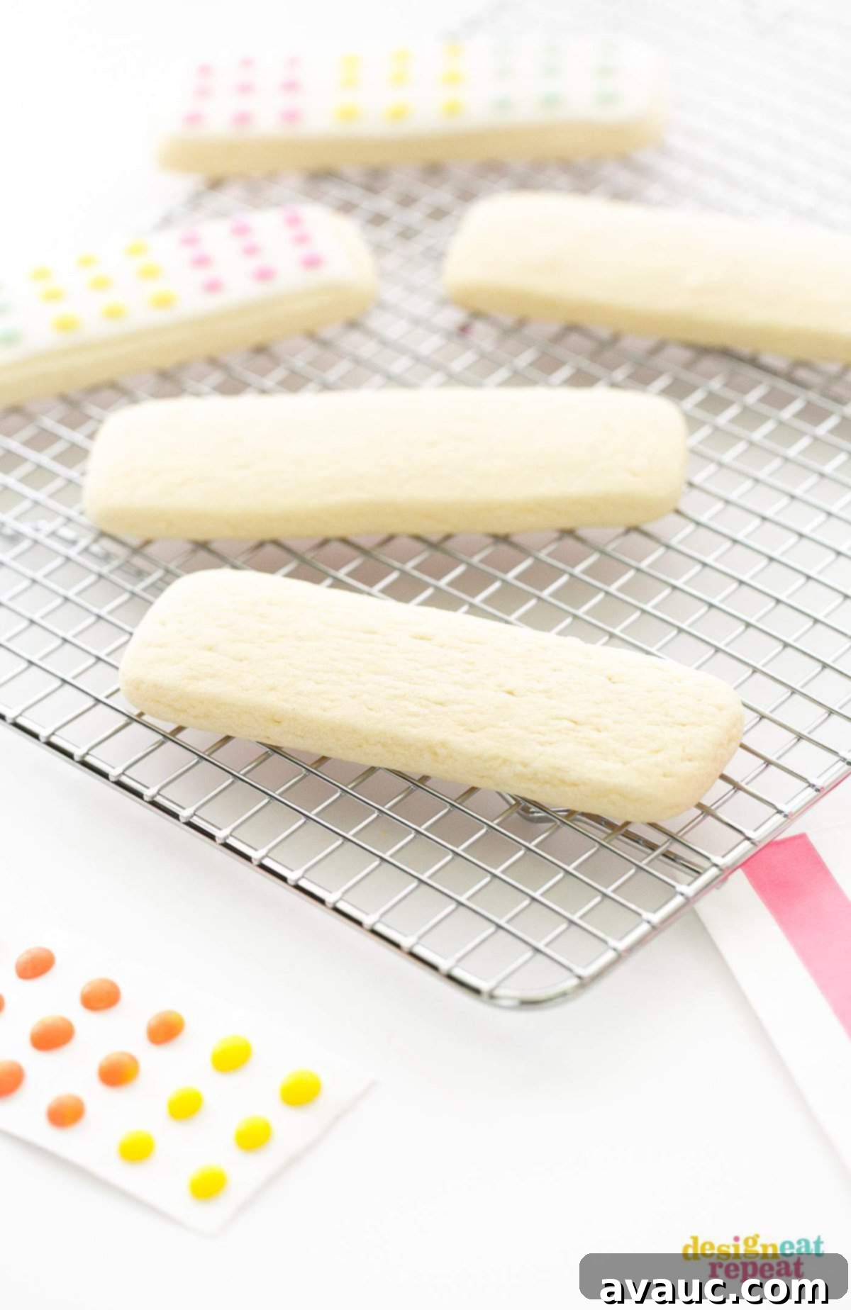 Close-up of three Candy Button Cookie Sticks, showcasing the vibrant colored icing dots on a white base, ready for any party.